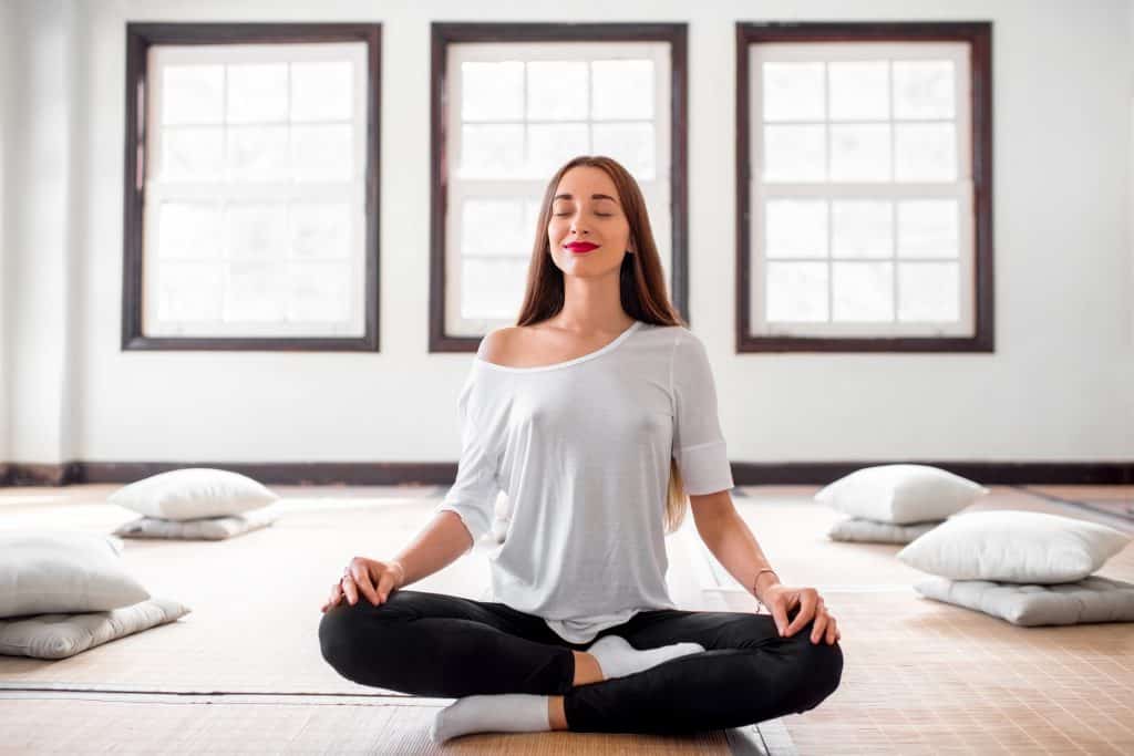 woman sitting in lotus (or easy pose)